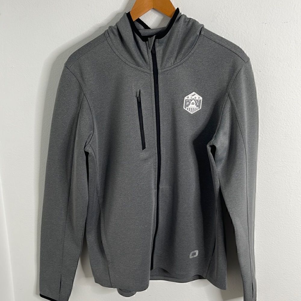 OGIO athletic zip up jacket.  Size Medium. Blue Pac embroidered emblem.